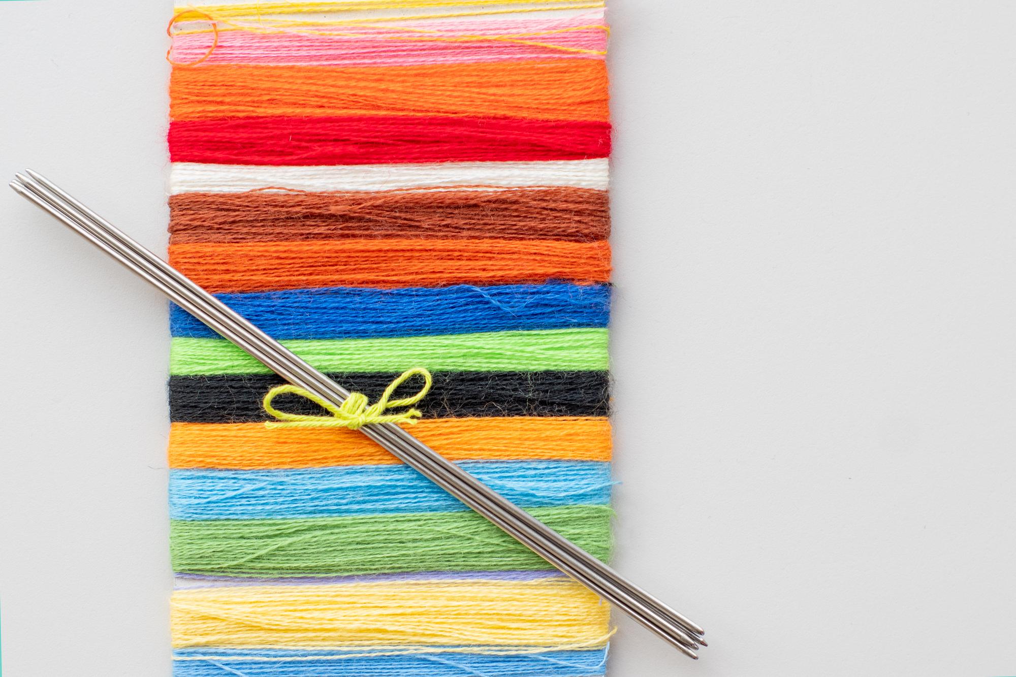 Selection of colorful threads and stitched patterns